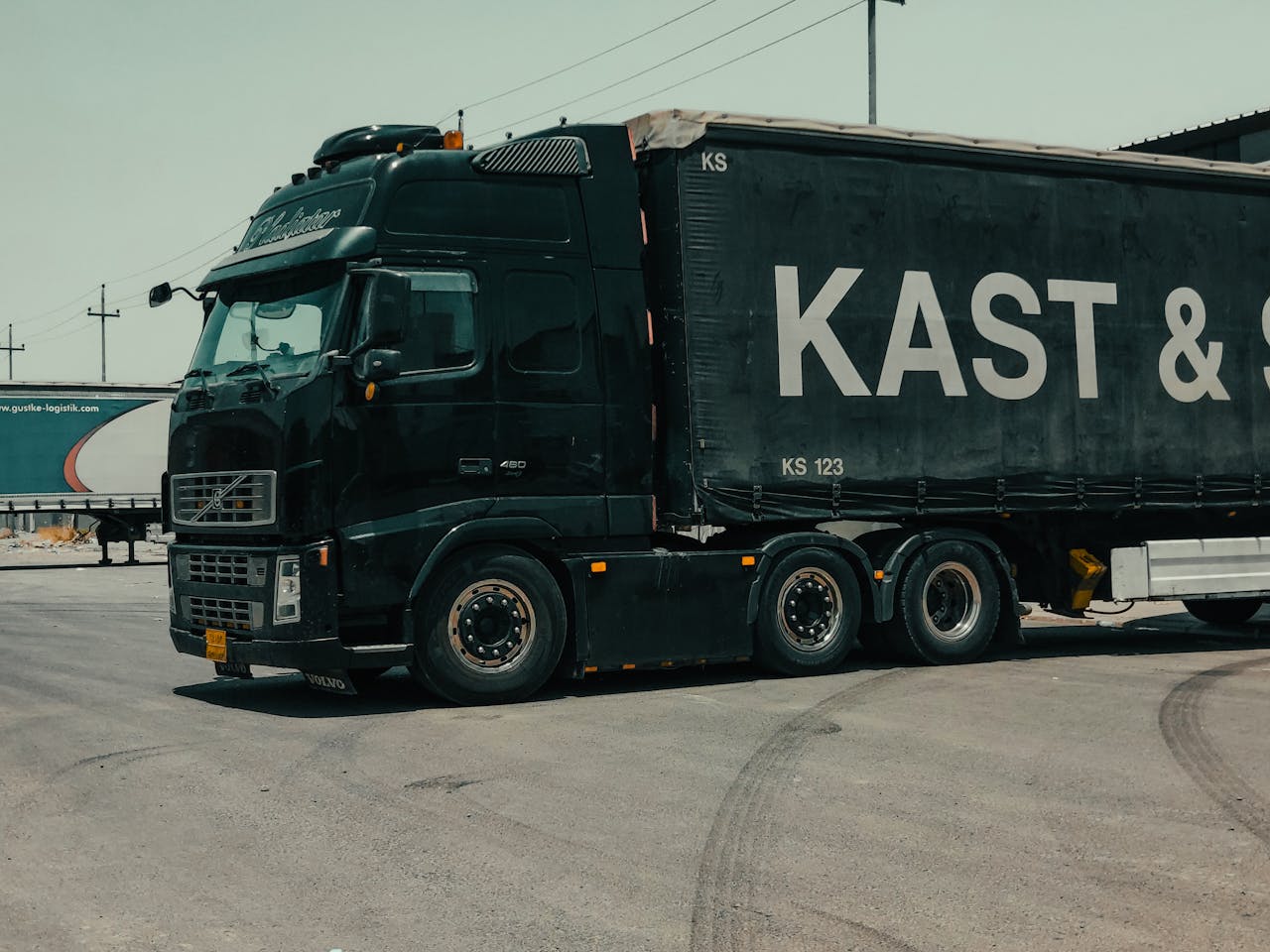 A large industrial truck parked in an urban setting, showcasing transportation industry visuals.